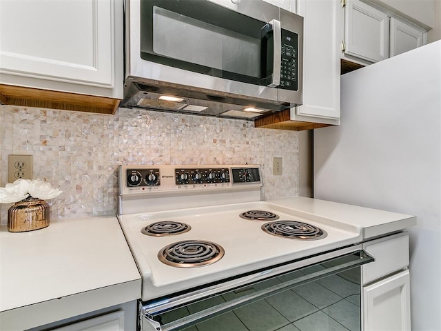 4400 Hemingway Dr Unit 221, Oklahoma City, OK 73118 - kitchen with stainless steel microwave, electric range, light countertops, and tasteful backsplash