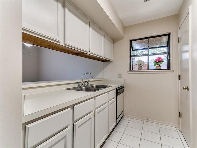 4400 Hemingway Dr Unit 221, Oklahoma City, OK 73118 - kitchen with light countertops, white cabinetry, dishwasher, and light tile patterned flooring