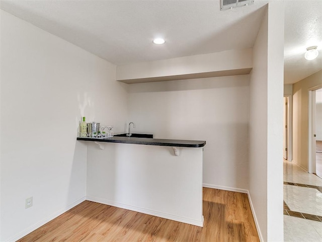 4400 Hemingway Dr Unit 221, Oklahoma City, OK 73118 - indoor wet bar with light wood-style flooring and recessed lighting