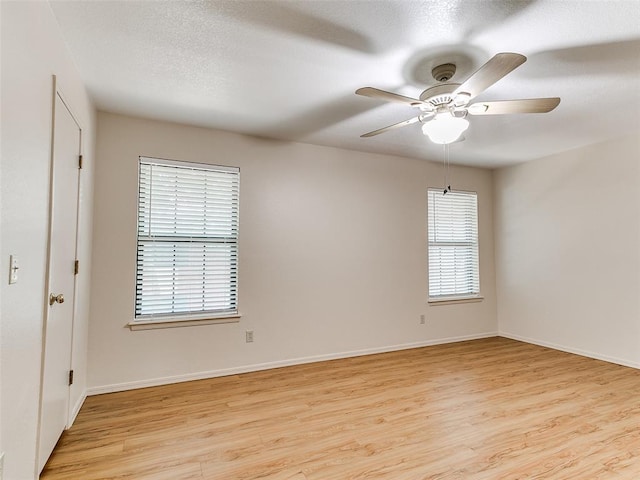 4400 Hemingway Dr Unit 221, Oklahoma City, OK 73118 - unfurnished room with light wood-style flooring, ceiling fan, and a textured ceiling