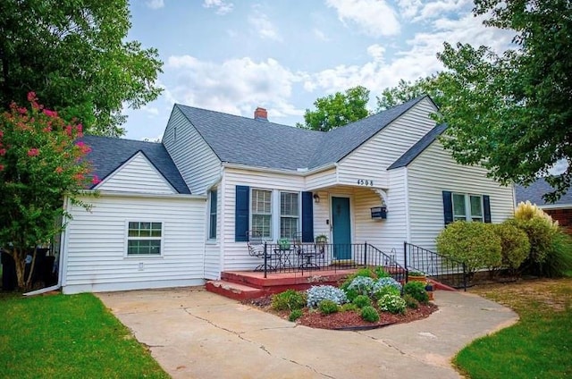 4508 N College Ave, Bethany, OK 73008 - bungalow featuring a porch, driveway, a shingled roof, and a chimney