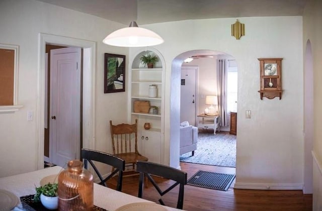 4508 N College Ave, Bethany, OK 73008 - dining room featuring arched walkways, wood finished floors, and built in features
