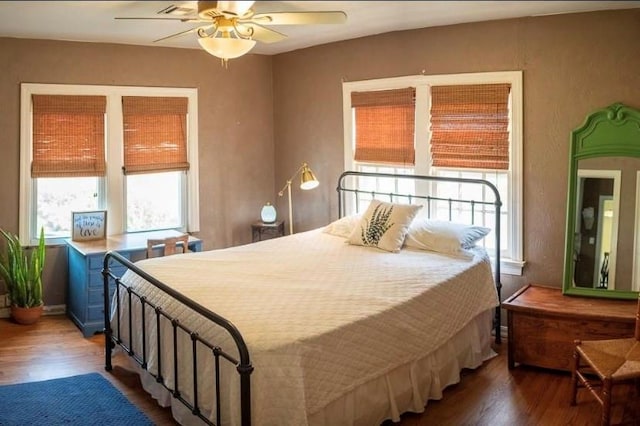 4508 N College Ave, Bethany, OK 73008 - bedroom with wood finished floors and ceiling fan