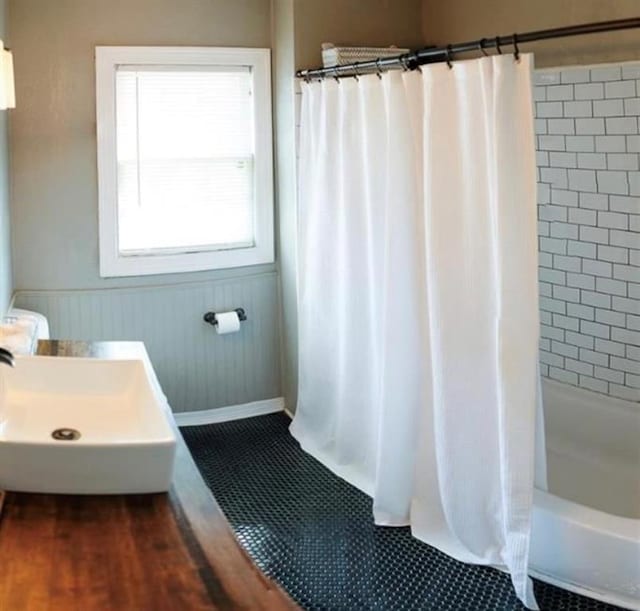 4508 N College Ave, Bethany, OK 73008 - bathroom featuring a wainscoted wall, shower / bath combo, and wood finished floors