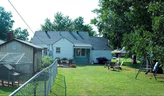 4508 N College Ave, Bethany, OK 73008 - rear view of house featuring roof with shingles, an outdoor structure, and a chimney