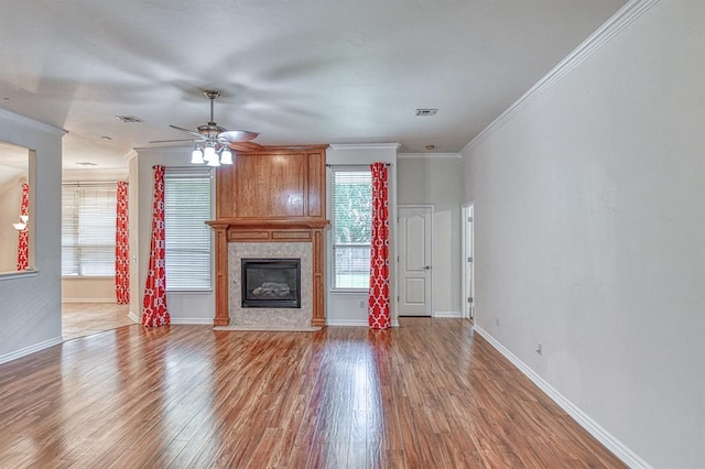 3900 Irvine Dr, Norman, OK 73072 - unfurnished living room featuring wood finished floors, crown molding, a ceiling fan, and a fireplace