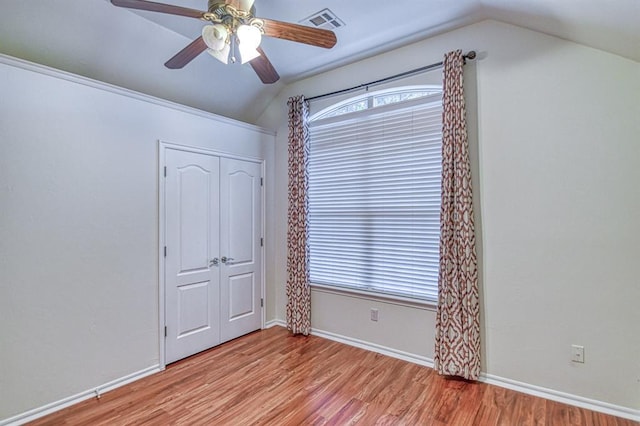 3900 Irvine Dr, Norman, OK 73072 - unfurnished bedroom featuring lofted ceiling, light wood-style floors, and ceiling fan