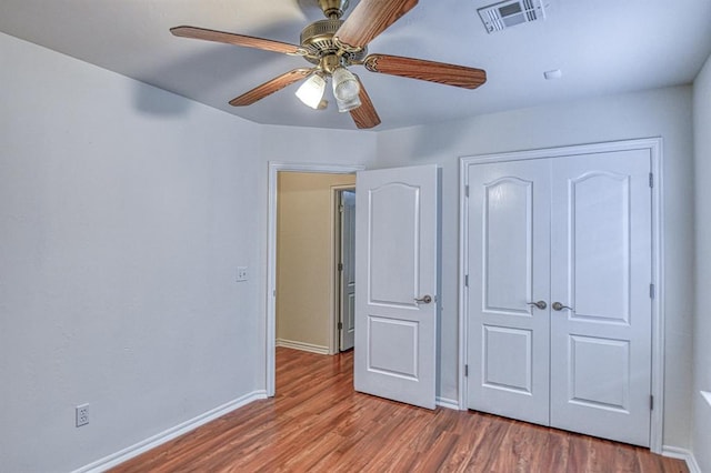 3900 Irvine Dr, Norman, OK 73072 - unfurnished bedroom featuring wood finished floors, a closet, and ceiling fan