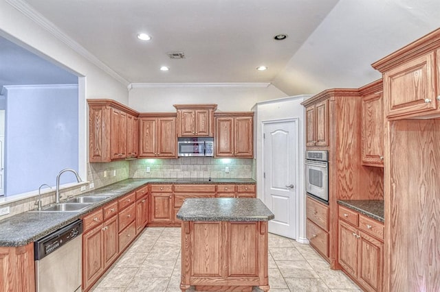 3900 Irvine Dr, Norman, OK 73072 - kitchen with stainless steel appliances, tasteful backsplash, a center island, crown molding, and recessed lighting