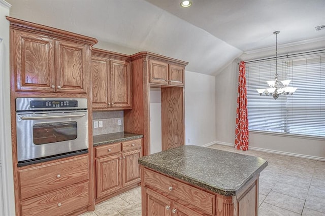 3900 Irvine Dr, Norman, OK 73072 - kitchen featuring stainless steel oven, dark countertops, vaulted ceiling, a kitchen island, and a chandelier