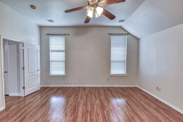 3900 Irvine Dr, Norman, OK 73072 - unfurnished bedroom with wood finished floors, vaulted ceiling, and a ceiling fan