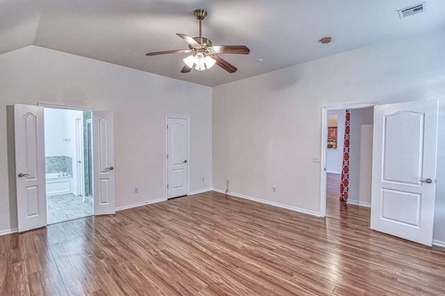 3900 Irvine Dr, Norman, OK 73072 - unfurnished bedroom with light wood-type flooring, lofted ceiling, a ceiling fan, and ensuite bath