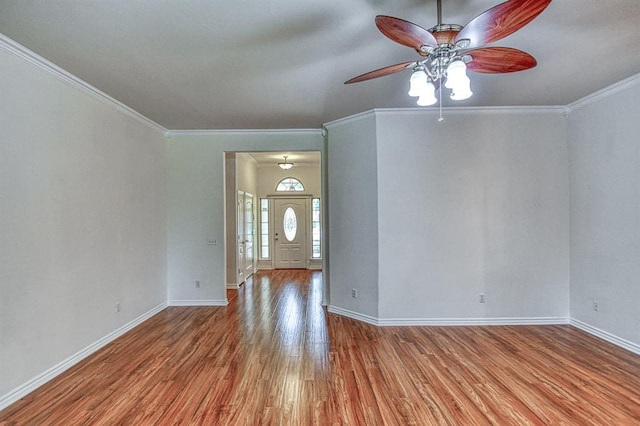 3900 Irvine Dr, Norman, OK 73072 - foyer entrance featuring wood finished floors, ceiling fan, and ornamental molding