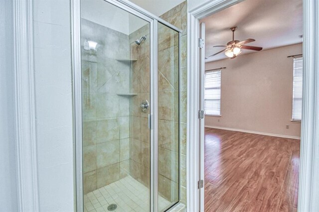 3900 Irvine Dr, Norman, OK 73072 - bathroom with ceiling fan, a shower stall, and wood finished floors