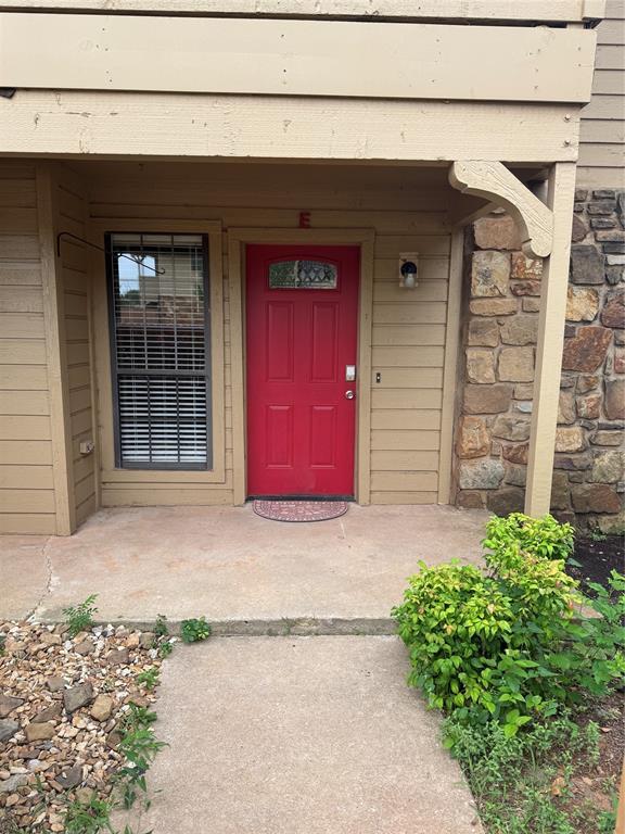 14321 N Pennsylvania Ave Unit 19E, Oklahoma City, OK 73134 - doorway to property featuring stone siding