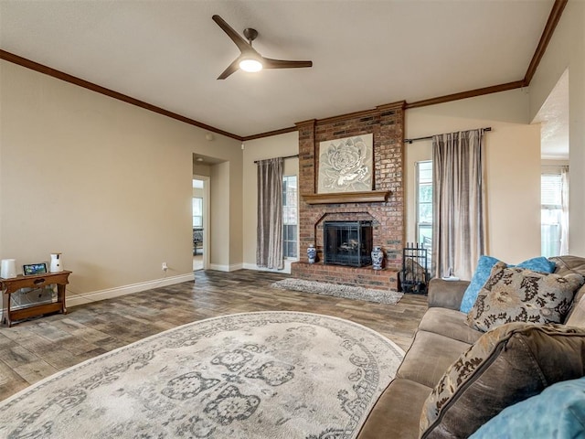 17213 Sunny Hollow Rd, Edmond, OK 73012 - living room with wood finished floors, a ceiling fan, ornamental molding, and a brick fireplace