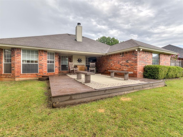 17213 Sunny Hollow Rd, Edmond, OK 73012 - back of property featuring brick siding, a chimney, a yard, and a wooden deck