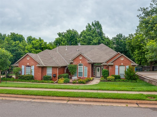 3716 Equestrian Ct, Edmond, OK 73034 - traditional home with brick siding, a front lawn, and a shingled roof