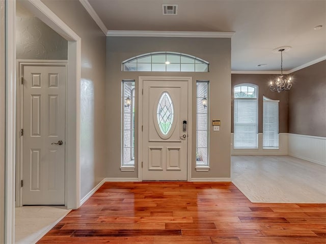 3716 Equestrian Ct, Edmond, OK 73034 - entryway with wood finished floors, a chandelier, and crown molding