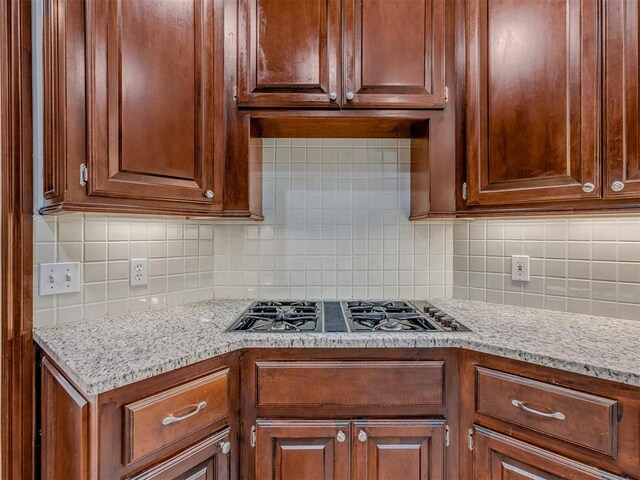 3716 Equestrian Ct, Edmond, OK 73034 - kitchen featuring stainless steel gas cooktop, backsplash, and light stone countertops