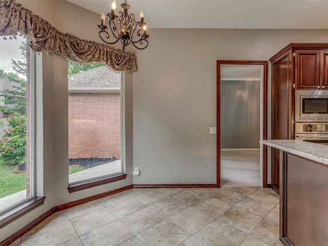 3716 Equestrian Ct, Edmond, OK 73034 - unfurnished dining area with a chandelier, plenty of natural light, and light tile patterned floors