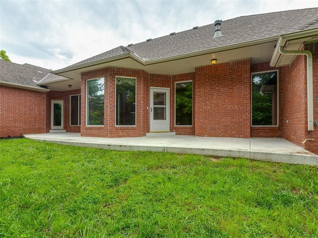 3716 Equestrian Ct, Edmond, OK 73034 - back of house featuring roof with shingles, a lawn, brick siding, and a patio