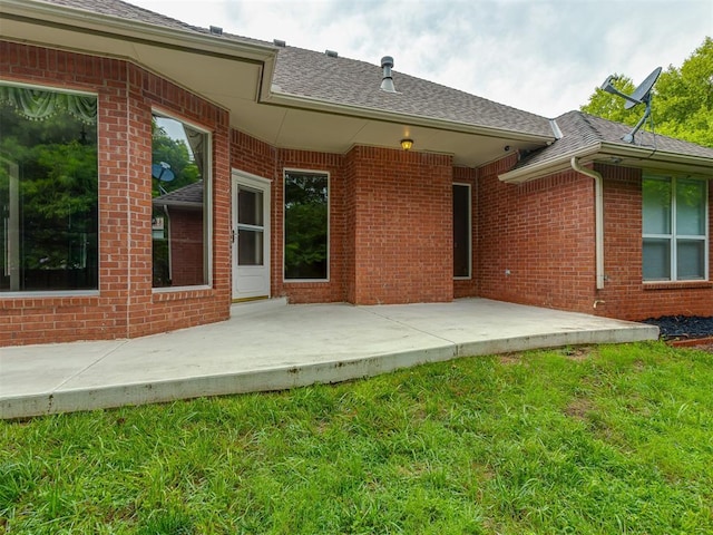 3716 Equestrian Ct, Edmond, OK 73034 - rear view of house with a patio area, a lawn, brick siding, and a shingled roof