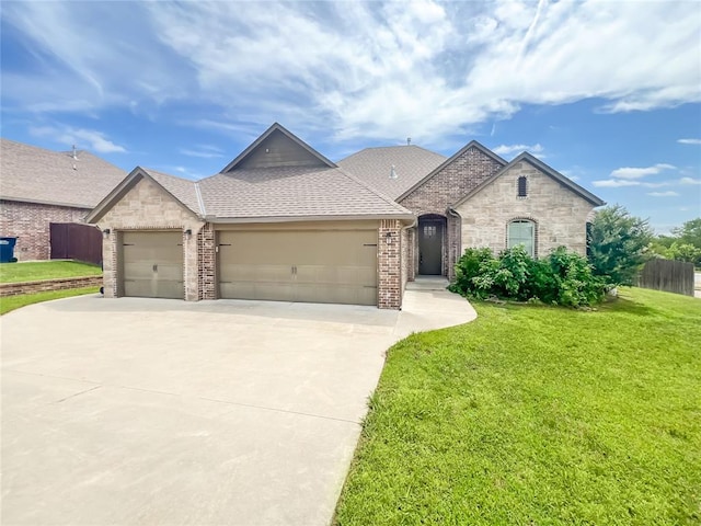 2010 Lakewood, Seminole, OK 74868 - french provincial home with a garage, concrete driveway, stone siding, and brick siding
