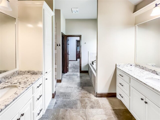 2010 Lakewood, Seminole, OK 74868 - bathroom featuring two vanities, stone finish flooring, and a relaxing tiled tub
