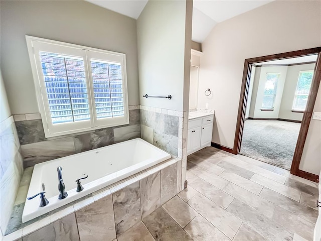 2010 Lakewood, Seminole, OK 74868 - bathroom featuring vanity, a tub with jets, and lofted ceiling