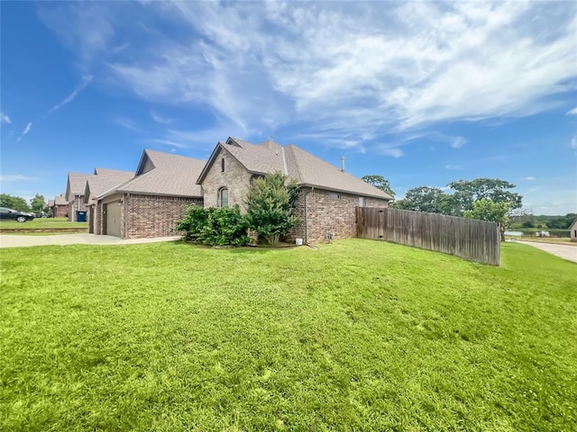 2010 Lakewood, Seminole, OK 74868 - view of home's exterior with brick siding, an attached garage, concrete driveway, and roof with shingles