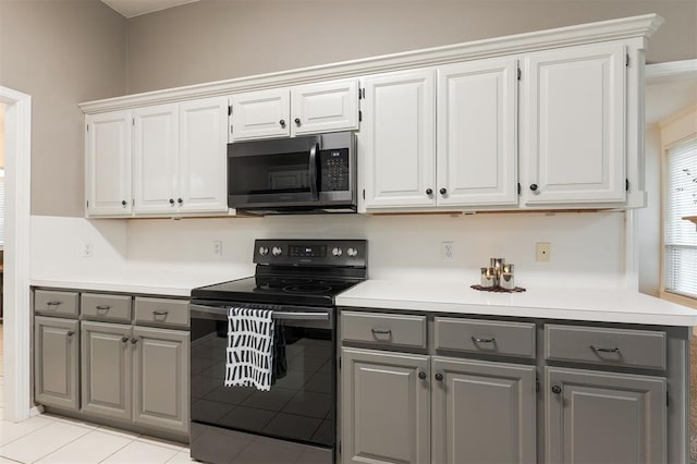 14213 Pecan Hollow Ter, Edmond, OK 73013 - kitchen featuring gray cabinets, black / electric stove, stainless steel microwave, light countertops, and white cabinets