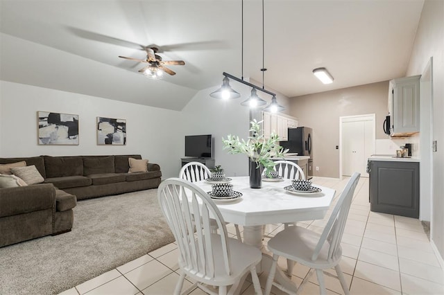 14213 Pecan Hollow Ter, Edmond, OK 73013 - dining room with light tile patterned flooring, a ceiling fan, light colored carpet, and lofted ceiling