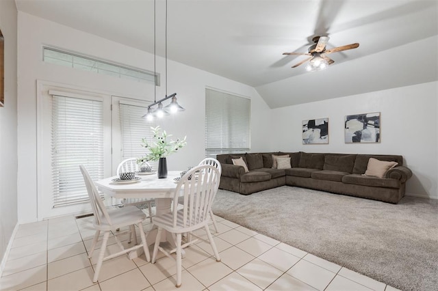 14213 Pecan Hollow Ter, Edmond, OK 73013 - dining space featuring ceiling fan, lofted ceiling, light tile patterned floors, and light carpet