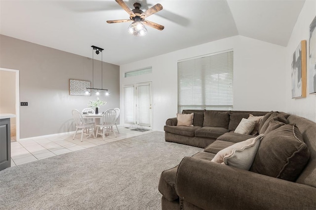 14213 Pecan Hollow Ter, Edmond, OK 73013 - living room featuring a ceiling fan, light tile patterned floors, vaulted ceiling, and light colored carpet