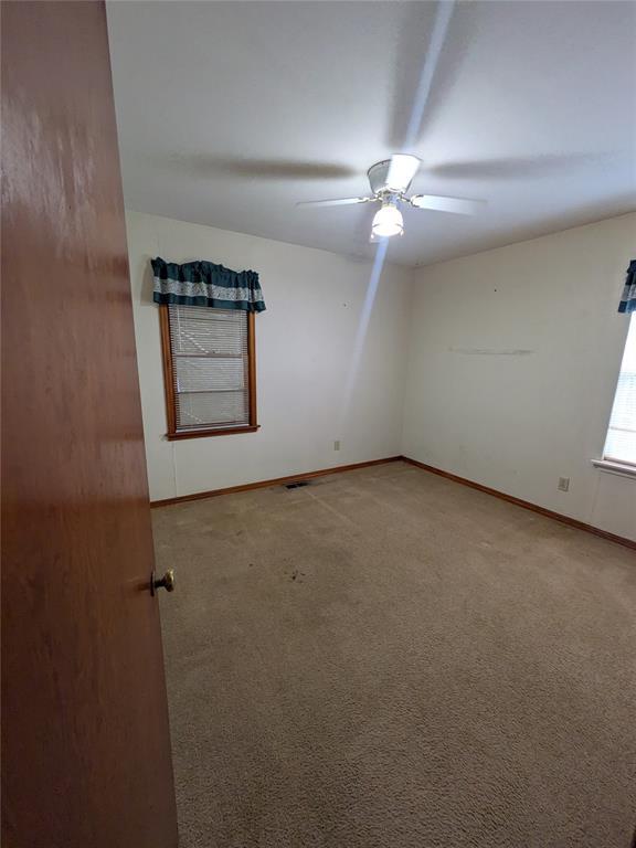 733 E Steed Dr, Midwest City, OK 73110 - unfurnished room featuring carpet floors and ceiling fan