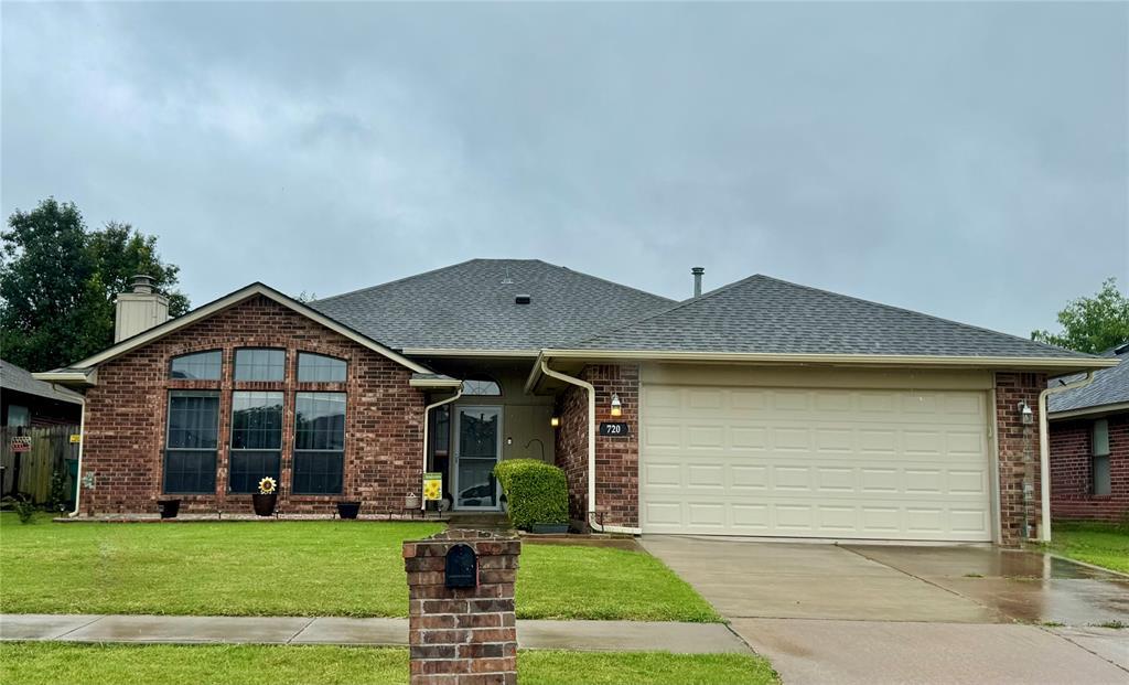 720 SW 153rd St, Oklahoma City, OK 73170 - ranch-style house with driveway, an attached garage, a front lawn, and roof with shingles