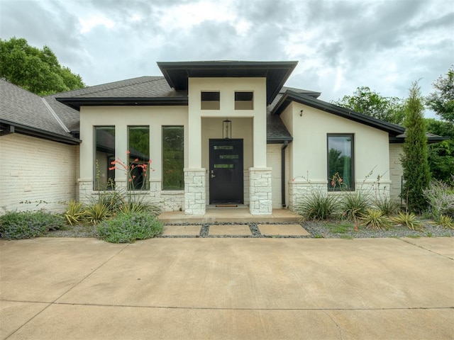 3604 Valley Creek Cir, Edmond, OK 73034 - view of front of house with stucco siding, stone siding, and a shingled roof