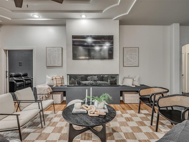 3604 Valley Creek Cir, Edmond, OK 73034 - living area featuring wood finished floors, a tray ceiling, and recessed lighting