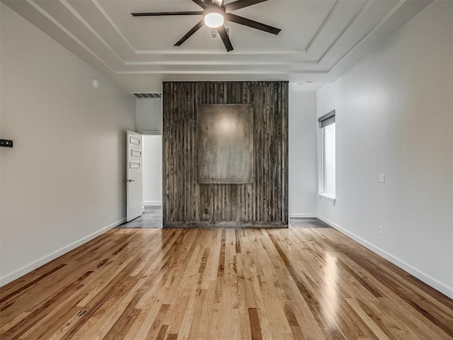 3604 Valley Creek Cir, Edmond, OK 73034 - spare room with ceiling fan, a tray ceiling, and wood finished floors