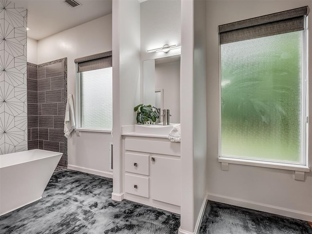 3604 Valley Creek Cir, Edmond, OK 73034 - bathroom featuring a freestanding tub, vanity, and healthy amount of natural light