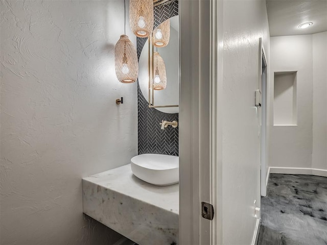 3604 Valley Creek Cir, Edmond, OK 73034 - bathroom featuring tile walls and a sink