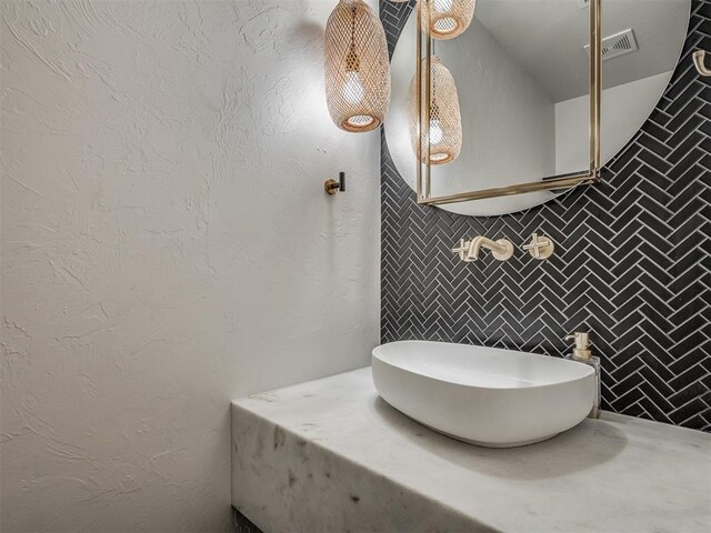 3604 Valley Creek Cir, Edmond, OK 73034 - bathroom featuring tasteful backsplash, tile walls, and vanity