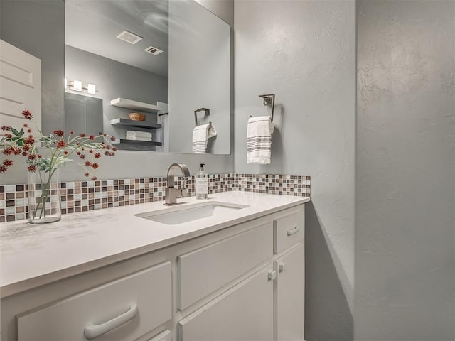 3604 Valley Creek Cir, Edmond, OK 73034 - bathroom with backsplash, vanity, and a textured wall