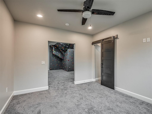 3604 Valley Creek Cir, Edmond, OK 73034 - unfurnished bedroom featuring a barn door, carpet flooring, recessed lighting, and ceiling fan