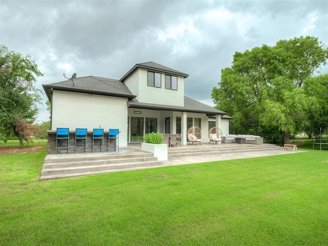 3604 Valley Creek Cir, Edmond, OK 73034 - rear view of house with a patio, an outdoor living space, a yard, and brick siding