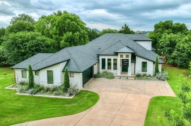 3604 Valley Creek Cir, Edmond, OK 73034 - view of front of property with stone siding, driveway, roof with shingles, a garage, and a front yard