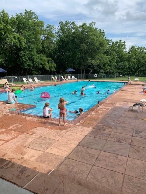 2525 Steeplechase Rd, Edmond, OK 73034 - community pool with a patio area and view of wooded area