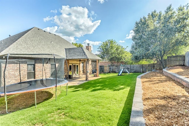 2525 Steeplechase Rd, Edmond, OK 73034 - fenced backyard with a trampoline, ceiling fan, a patio area, and a playground