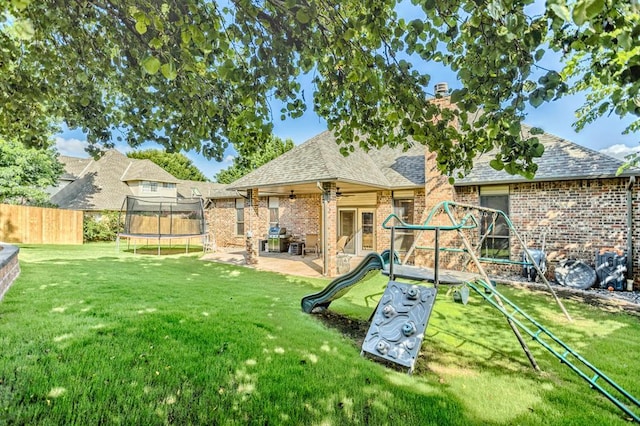 2525 Steeplechase Rd, Edmond, OK 73034 - view of yard with a trampoline, a patio area, a ceiling fan, and a playground